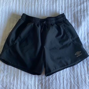 Black Umbro athletic shorts.